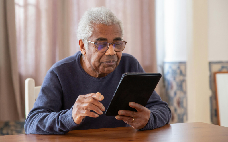 Senior using a free government tablet with internet at home for daily online activities